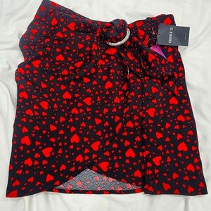 Black skirt with red heart prints. size M